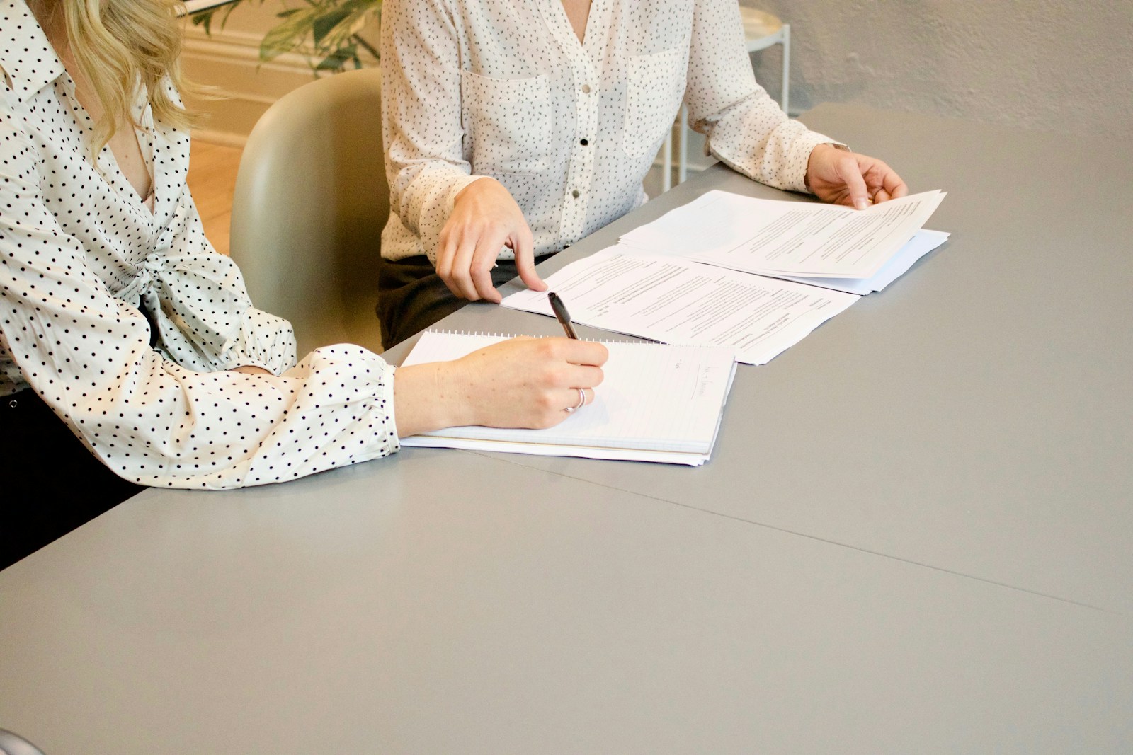 Recruiter reviewing a candidate's CV at a desk